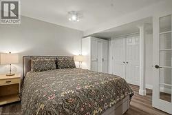 Bedroom with dark wood-style flooring and a closet - 