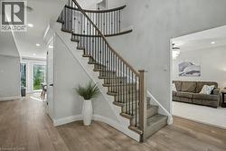 Stairs with recessed lighting and wood finished floors - 