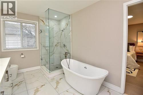 Full bathroom featuring ensuite bath, vanity, light marble finish flooring, a marble finish shower, and a freestanding tub - 5109 Blue Spruce Avenue, Burlington, ON - Indoor Photo Showing Bathroom