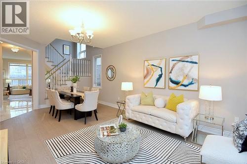 Living area featuring stairs, wood finished floors, and a chandelier - 5109 Blue Spruce Avenue, Burlington, ON - Indoor Photo Showing Living Room