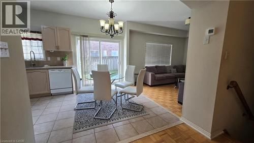 Dining room with a chandelier and light tile patterned floors - 3688 Emery Drive, Mississauga, ON - Indoor