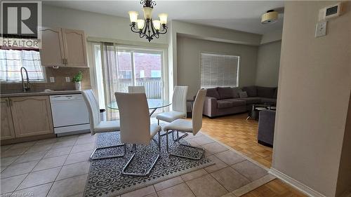 Dining space with light tile patterned floors and a chandelier - 3688 Emery Drive, Mississauga, ON - Indoor