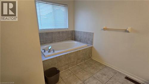 Bathroom with a bath and tile patterned floors - 3688 Emery Drive, Mississauga, ON - Indoor Photo Showing Bathroom