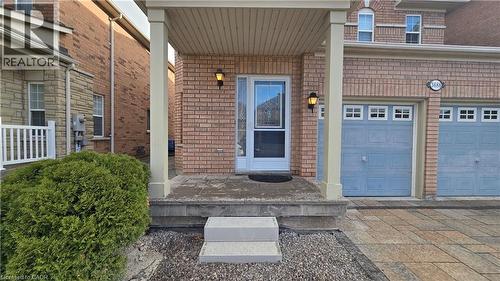 Property entrance with brick siding, an attached garage, covered porch, and driveway - 3688 Emery Drive, Mississauga, ON - Outdoor