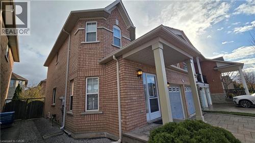 View of side of home featuring a garage and a central air condition unit - 3688 Emery Drive, Mississauga, ON - Outdoor