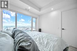 Bedroom featuring access to exterior, recessed lighting, and wood finished floors - 
