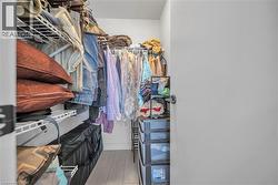 Spacious closet featuring light wood-style flooring - 