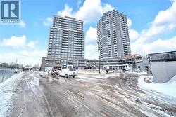 Snow covered property with a view of apartment building / complex - 