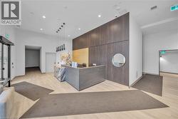 Reception with a towering ceiling, recessed lighting, and wood walls - 
