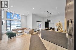 Living area featuring a high ceiling, recessed lighting, and light wood finished floors - 