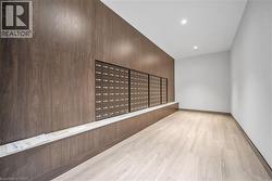 Empty room with mail area, light wood-style floors, and recessed lighting - 