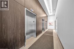 Hall with elevator and light wood-style flooring - 