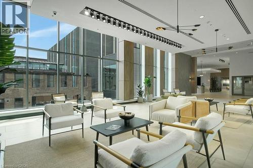 Community lobby featuring a towering ceiling, a wall of windows, and a surveillance system - 15 Glebe Street Unit# 1511, Cambridge, ON - Indoor Photo Showing Other Room