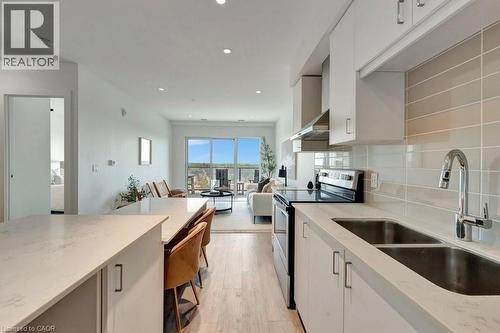 Kitchen featuring electric range, light stone counters, light wood-type flooring, and recessed lighting - 15 Glebe Street Unit# 1511, Cambridge, ON - Indoor Photo Showing Kitchen With Double Sink