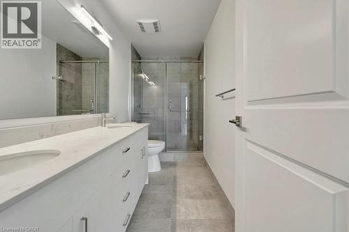 Full bathroom with double vanity, a stall shower, and tile patterned floors - 15 Glebe Street Unit# 1511, Cambridge, ON - Indoor Photo Showing Bathroom