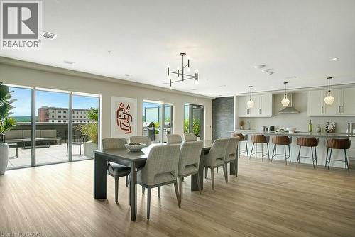 Dining room featuring healthy amount of natural light, a chandelier, light wood-style floors, and recessed lighting - 15 Glebe Street Unit# 1511, Cambridge, ON - Indoor Photo Showing Dining Room