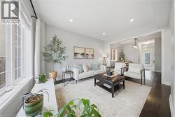 Living area featuring wood finished floors and recessed lighting - 