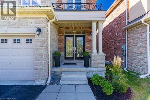 Doorway to property featuring a garage, stone siding, french doors, and a porch - 8 Summerberry Way, Hamilton, ON - Outdoor