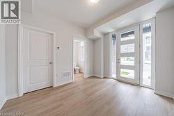 Foyer entrance with baseboards and light wood-style flooring - 