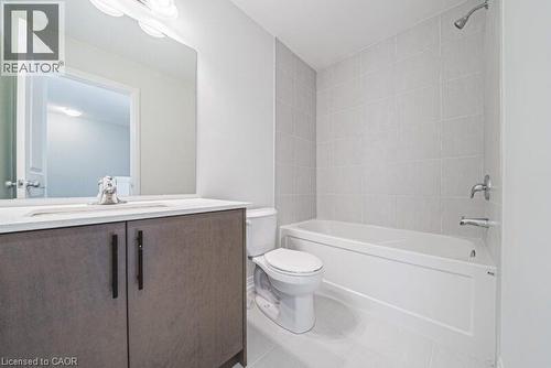 Full bath featuring shower / bathtub combination, vanity, and light tile patterned floors - 155 Equestrian Way Unit# 22, Cambridge, ON - Indoor Photo Showing Bathroom