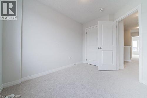 Unfurnished bedroom with light colored carpet and baseboards - 155 Equestrian Way Unit# 22, Cambridge, ON - Indoor Photo Showing Other Room