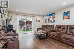 Living area featuring hardwood / wood-style flooring and recessed lighting - 