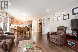 Living room with recessed lighting and dark wood finished floors - 
