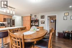 Dining space with dark wood finished floors and baseboards - 