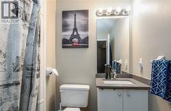 Bathroom featuring curtained shower and vanity - 