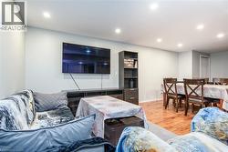 Living room featuring light wood-type flooring and recessed lighting - 
