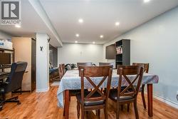 Dining room with light wood-type flooring, recessed lighting, and an office area - 