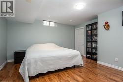 Bedroom with dark wood-style flooring and recessed lighting - 