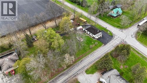 Property with a white exterior and dark roof, positioned at a road intersection - 740 Hillcrest Road, Simcoe, ON - Outdoor With View