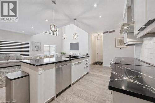 Kitchen with dishwasher, light wood-type flooring, open floor plan, extractor fan, and white cabinets - 972 Stonecliffe Walk Unit# 18, Kitchener, ON - Indoor Photo Showing Kitchen With Upgraded Kitchen