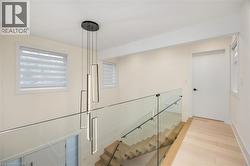 Stairway with healthy amount of natural light and wood finished floors - 