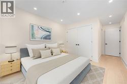 Bedroom with recessed lighting, light wood-type flooring, and a closet - 