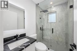 Bathroom featuring vanity and a shower stall - 