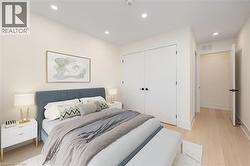 Bedroom with recessed lighting, light wood-style flooring, and a closet - 