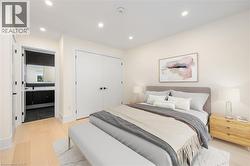 Bedroom featuring light wood finished floors, recessed lighting, and a closet - 