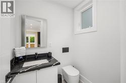 Bathroom with vanity and baseboards - 