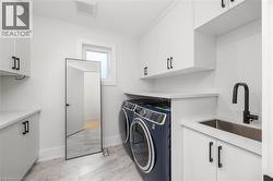 Laundry room with cabinet space and washer and dryer - 