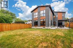 Rear view of property featuring a fenced backyard, a patio area, and stucco siding - 