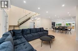 Living room with recessed lighting, stairs, and light wood-style flooring - 