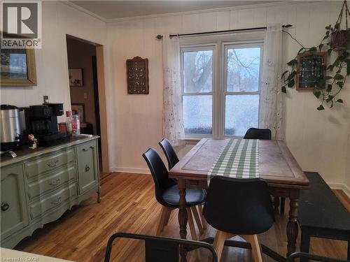 Dining area featuring light wood-style flooring and wood walls - 509 Queensway W, Simcoe, ON - Indoor Photo Showing Dining Room