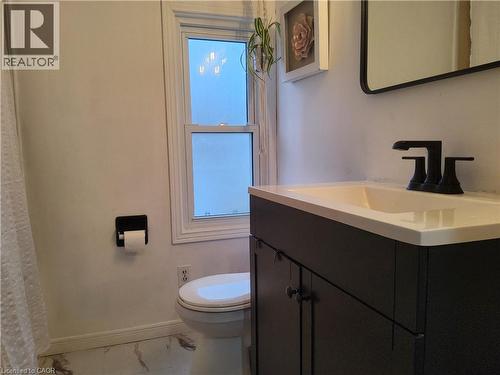 2nd floor Bathroom with vanity, marble look tile flooring, and healthy amount of natural light - 509 Queensway W, Simcoe, ON - Indoor Photo Showing Bathroom