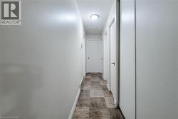 Hall featuring baseboards and a textured ceiling - 