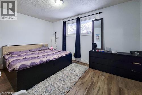 Bedroom with a textured ceiling and wood finished floors - 758 Stone Church Road E, Hamilton, ON - Indoor Photo Showing Bedroom