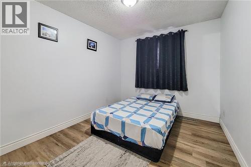 Bedroom featuring a textured ceiling and wood finished floors - 758 Stone Church Road E, Hamilton, ON - Indoor Photo Showing Bedroom