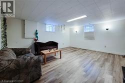 Living room featuring light wood finished floors and baseboards - 