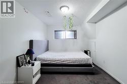 Bedroom featuring a textured ceiling and carpet - 